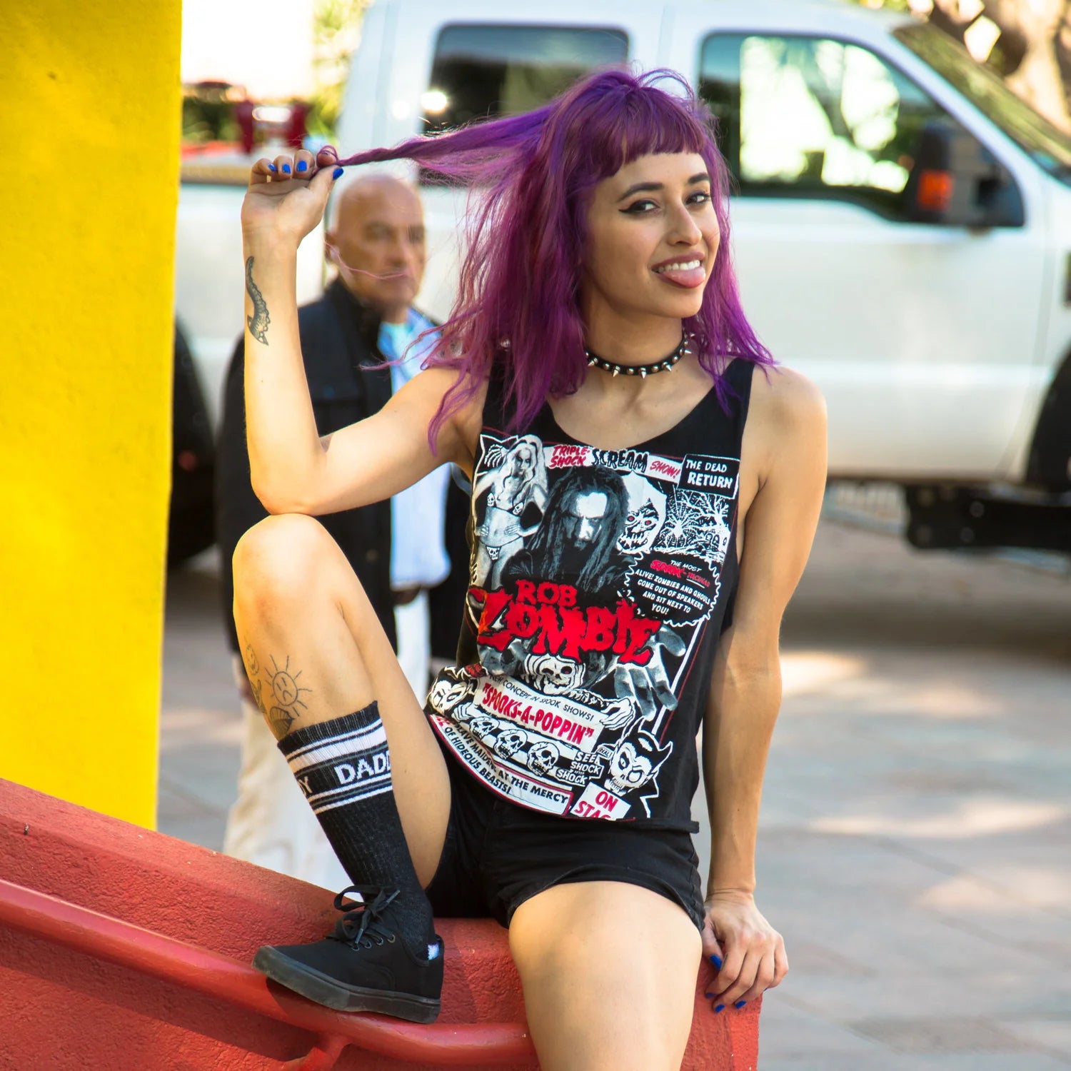 A woman wearing a pair of black and white crew socks that read "daddy."