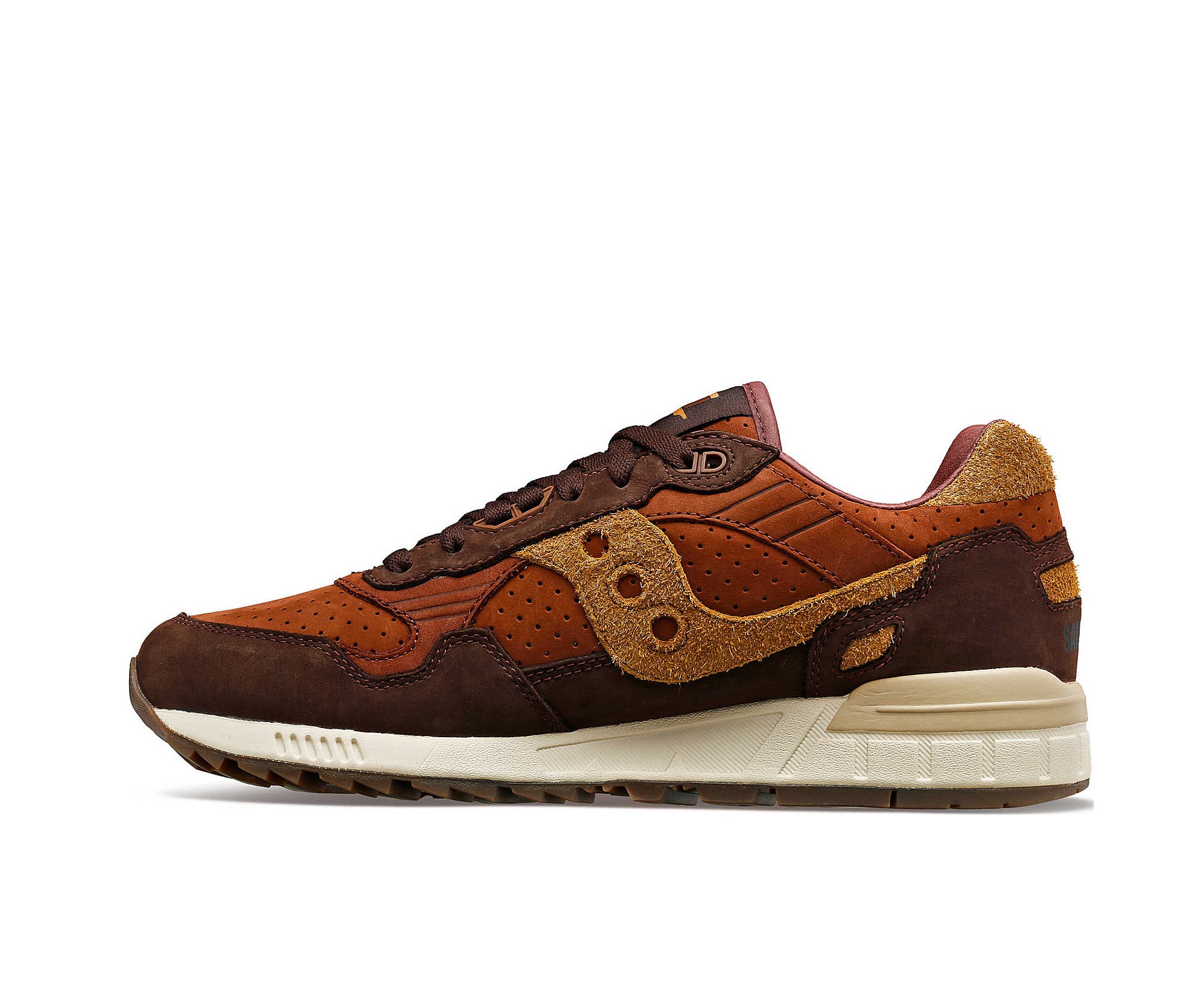 A suede low-cut Saucony sneaker in various shades of rich brown.