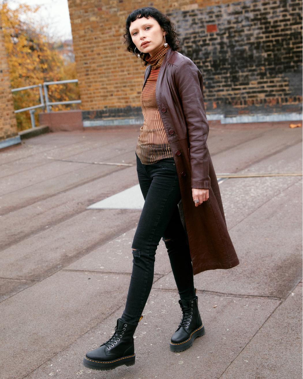 A mid-ankle height, laced, black leather platform boot.