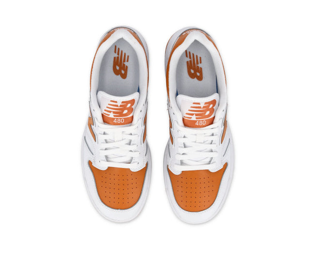 A white and orange leather basketball sneaker from New Balance.