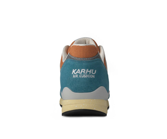A teal, orange, and tan sneaker from Karhu.