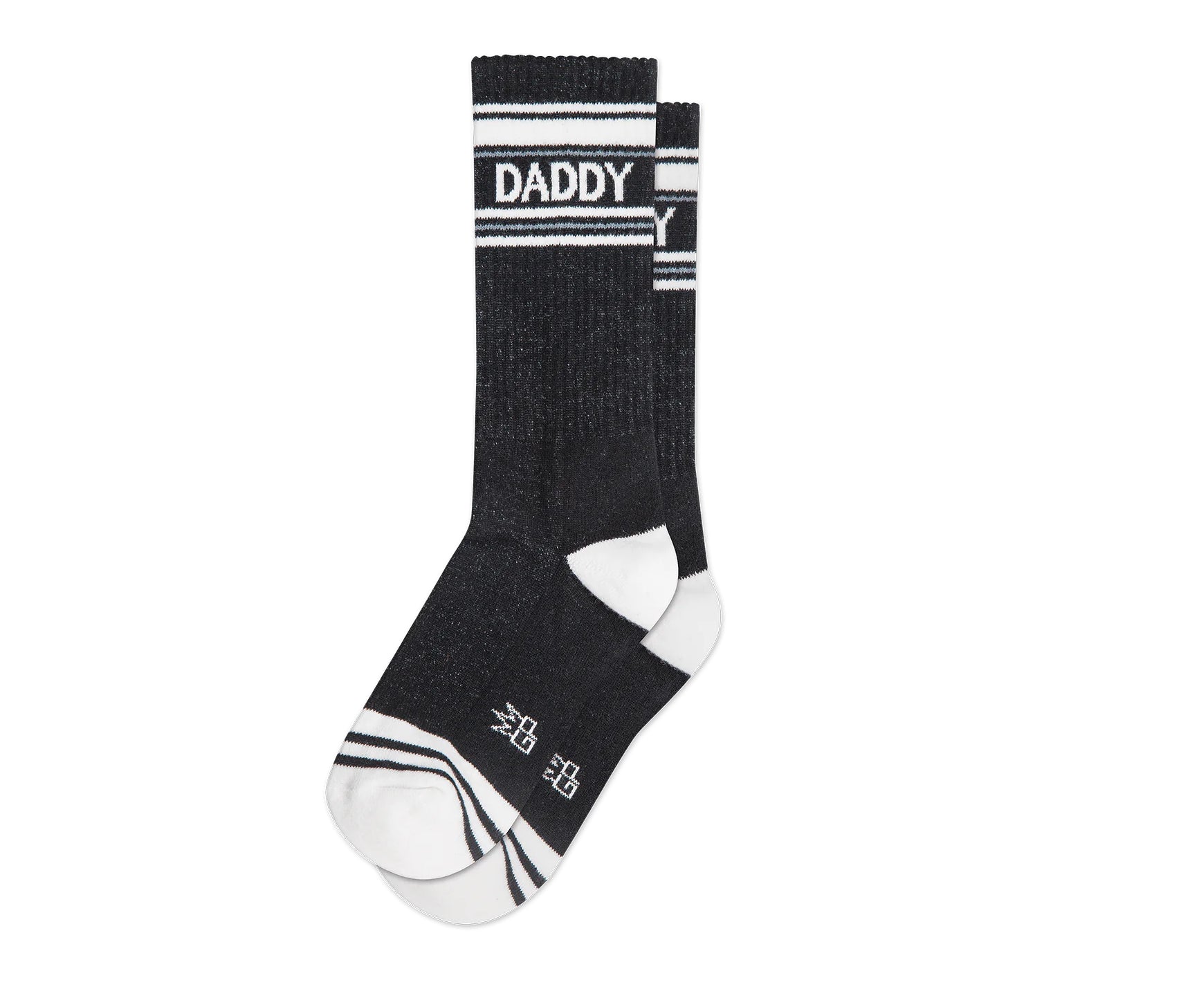 A pair of black and white crew socks that read "daddy" with the Gumball Poodle logo on the arch.
