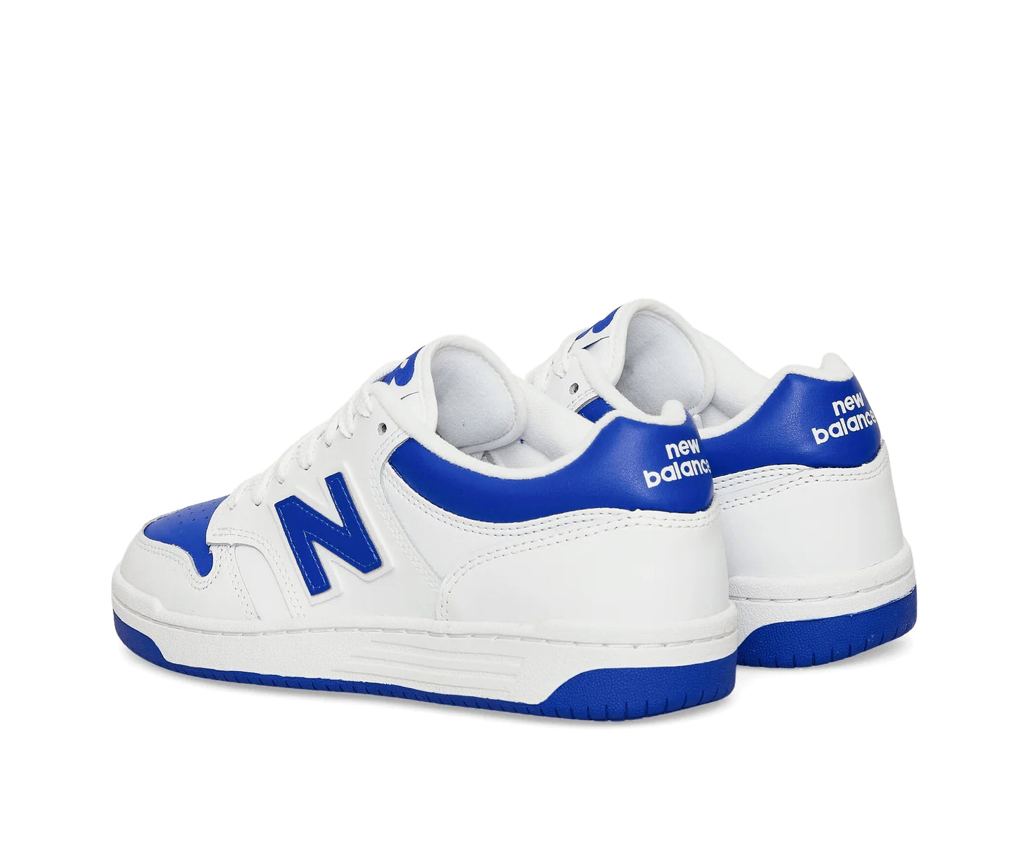 A white leather New Balance basketball shoe with cobalt blue accents.