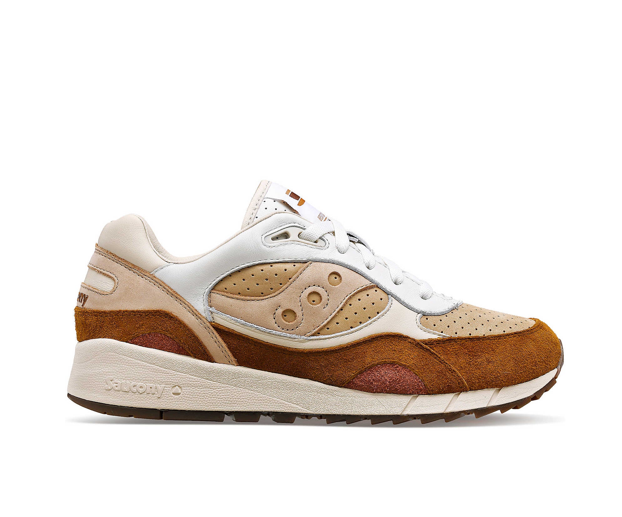 A suede low-cut Saucony sneaker in various shades of light brown.