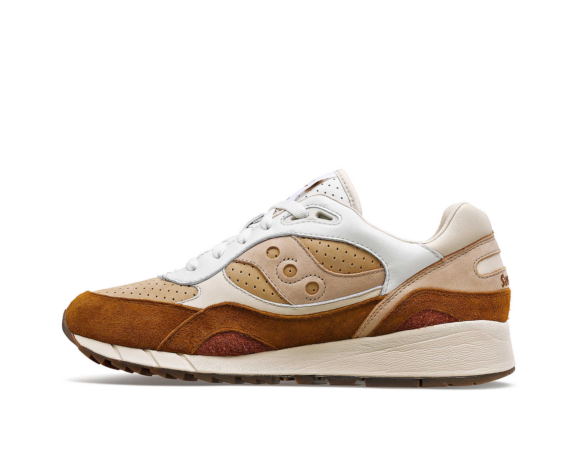 A suede low-cut Saucony sneaker in various shades of light brown.