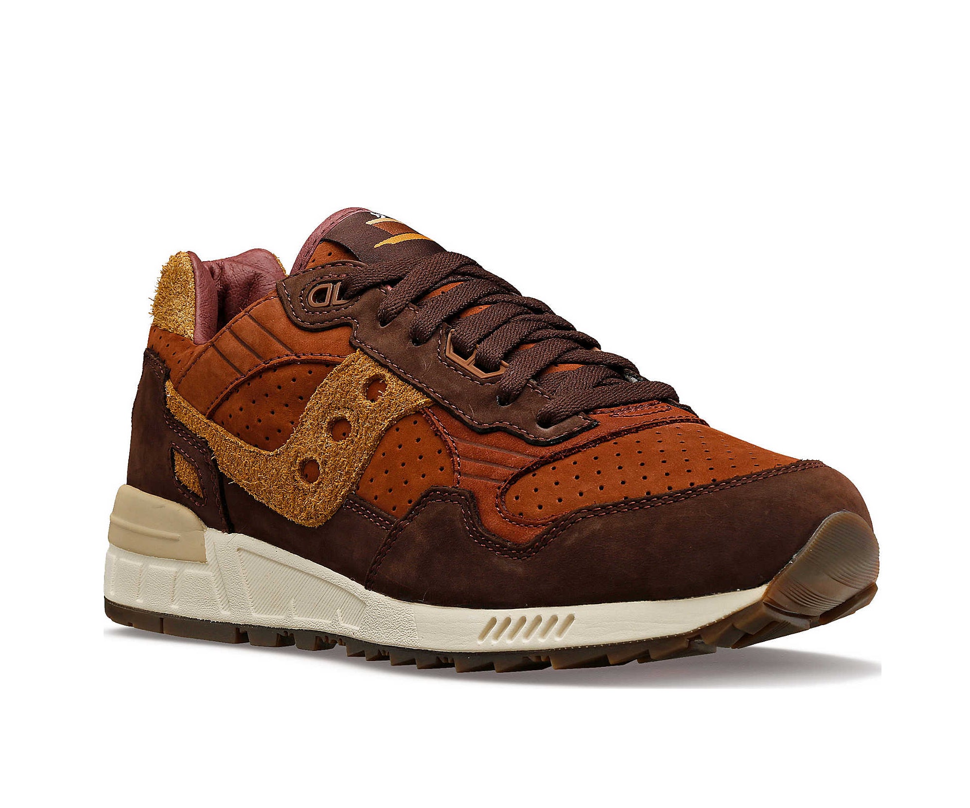 A suede low-cut Saucony sneaker in various shades of rich brown.