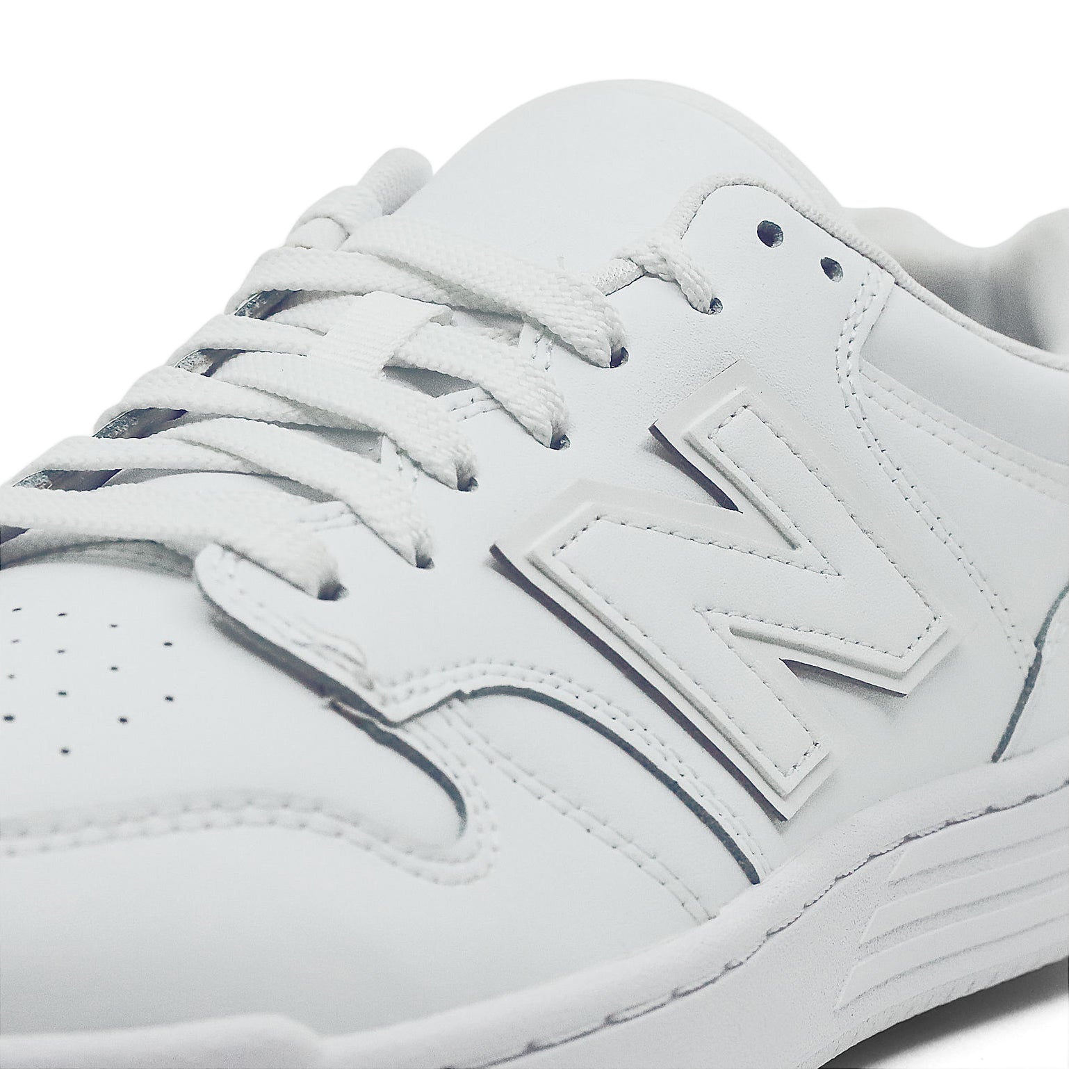 A monochrome white leather basketball sneaker from New Balance.